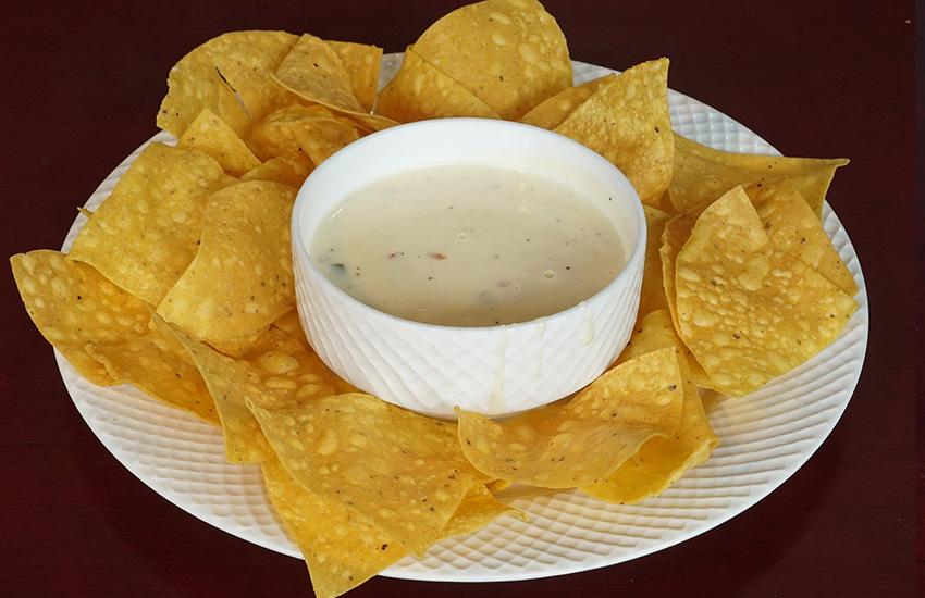 Tortilla chips with queso dip