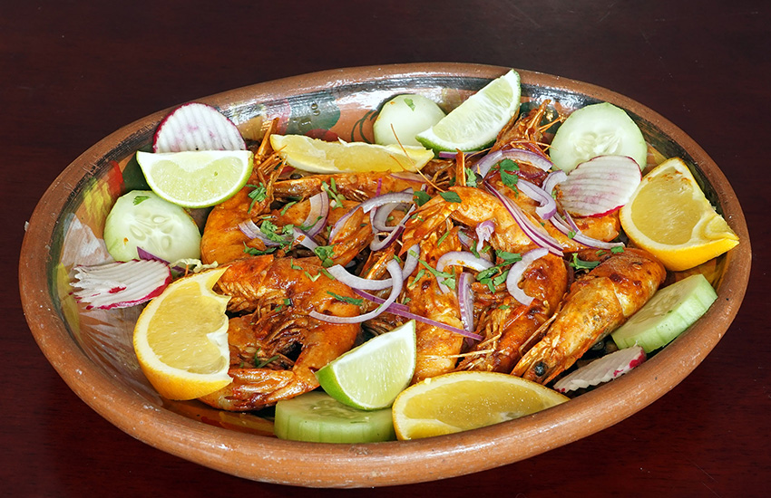 Spiced shrimp platter with citrus and fresh vegetables