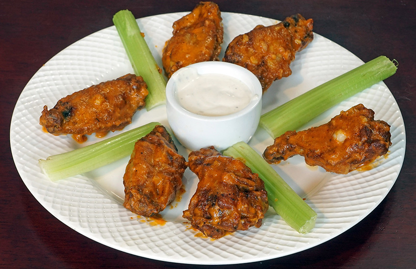 Buffalo wings with celery and ranch dipping sauce